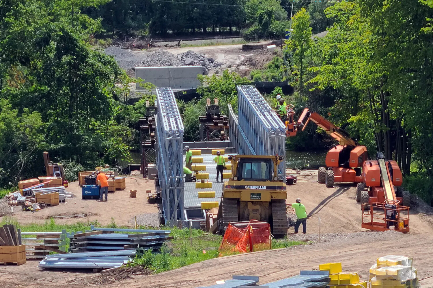 BVR assembles a bridge over land and translated using rollers on towers across the Oatka Creek.