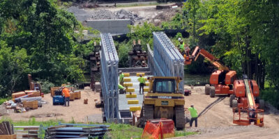 BVR assembles a bridge over land and translated using rollers on towers across the Oatka Creek.