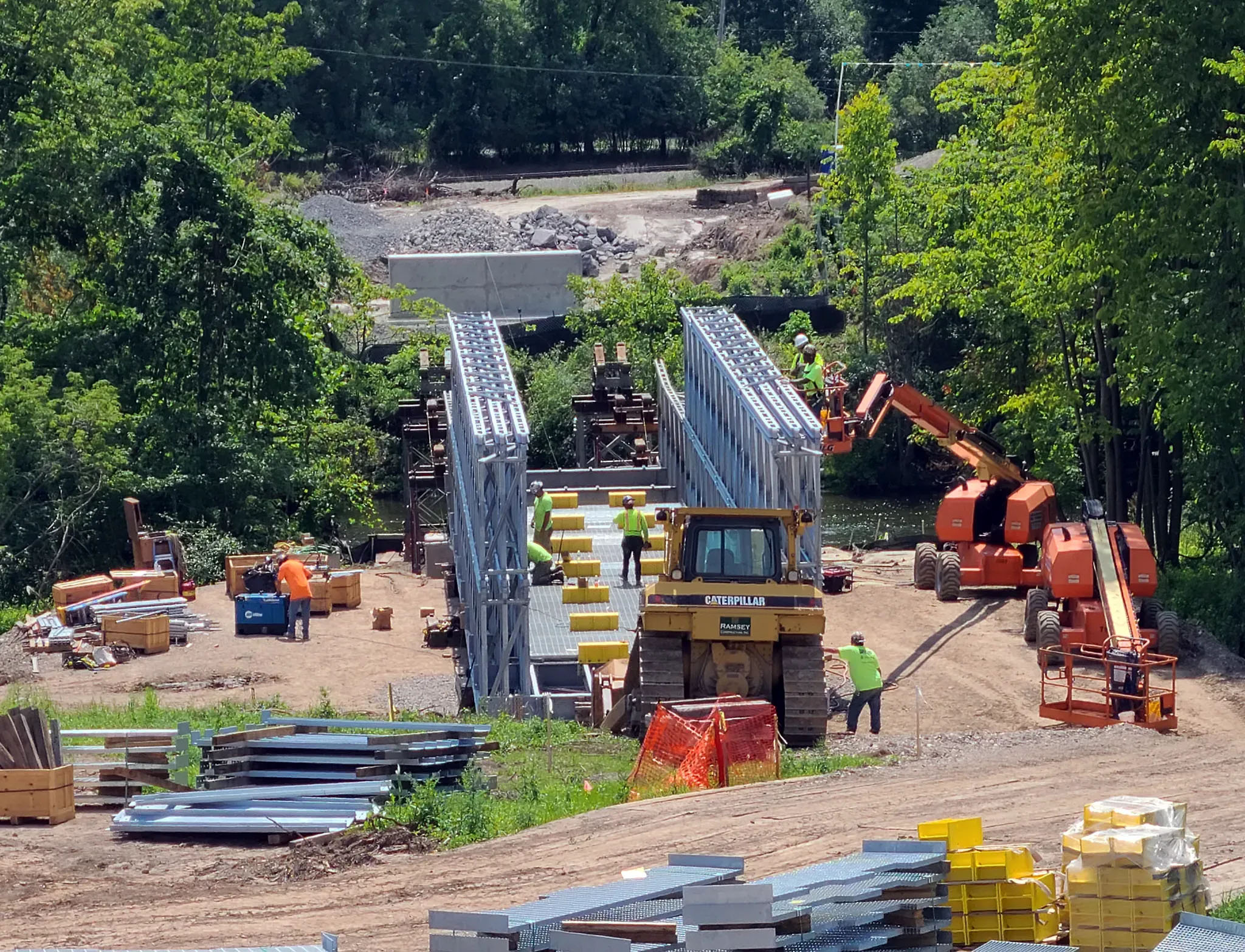 BVR assembles a bridge over land and translated using rollers on towers across the Oatka Creek.